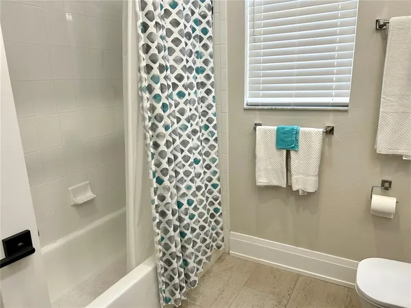 a bathroom with a shower curtain and a sink