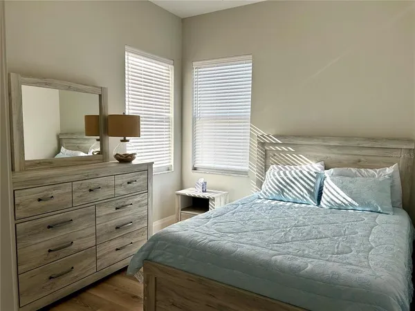 a bedroom with a bed and a dresser