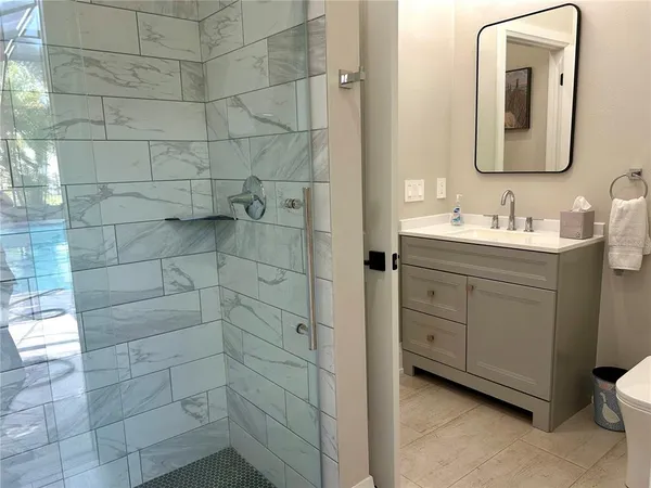 a bathroom with a double vanity sink a mirror and a shower