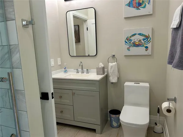 a bathroom with a toilet a sink and mirror