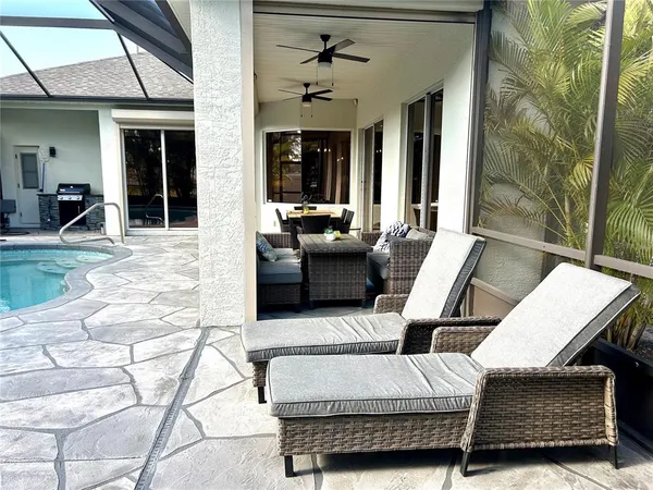 a swimming pool with patio outdoor seating and yard
