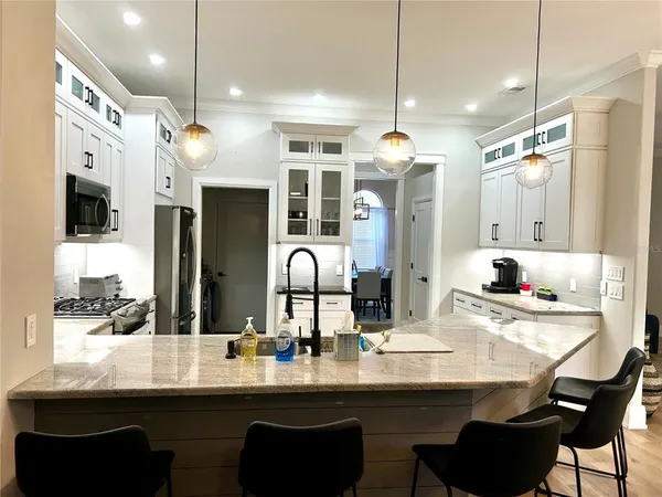 a kitchen with a sink refrigerator and cabinets