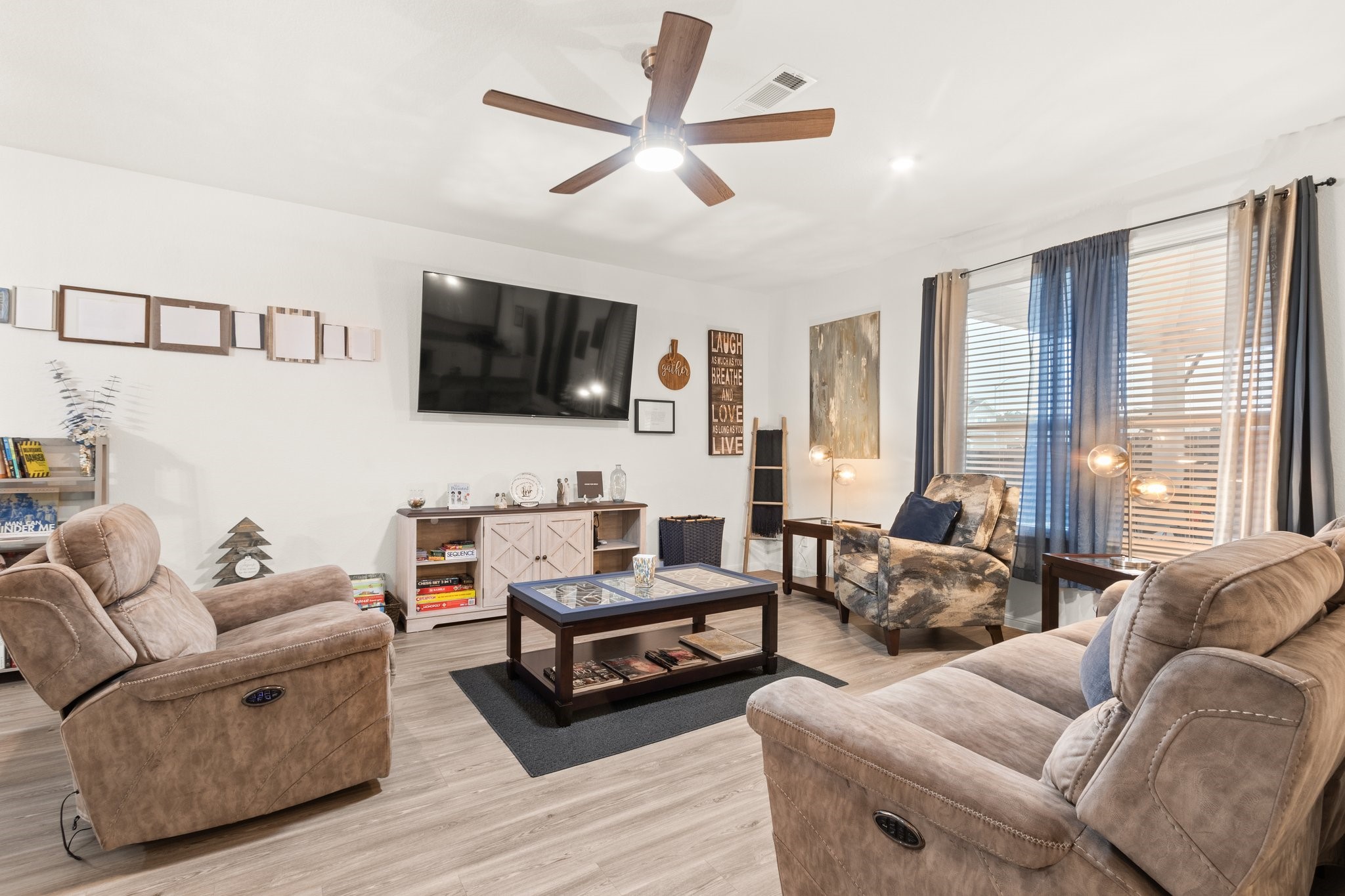 5834 Finely Run St Spring Spring, TX 77373 - Photo 13 of 50 a living room with furniture a flat screen tv and a large window