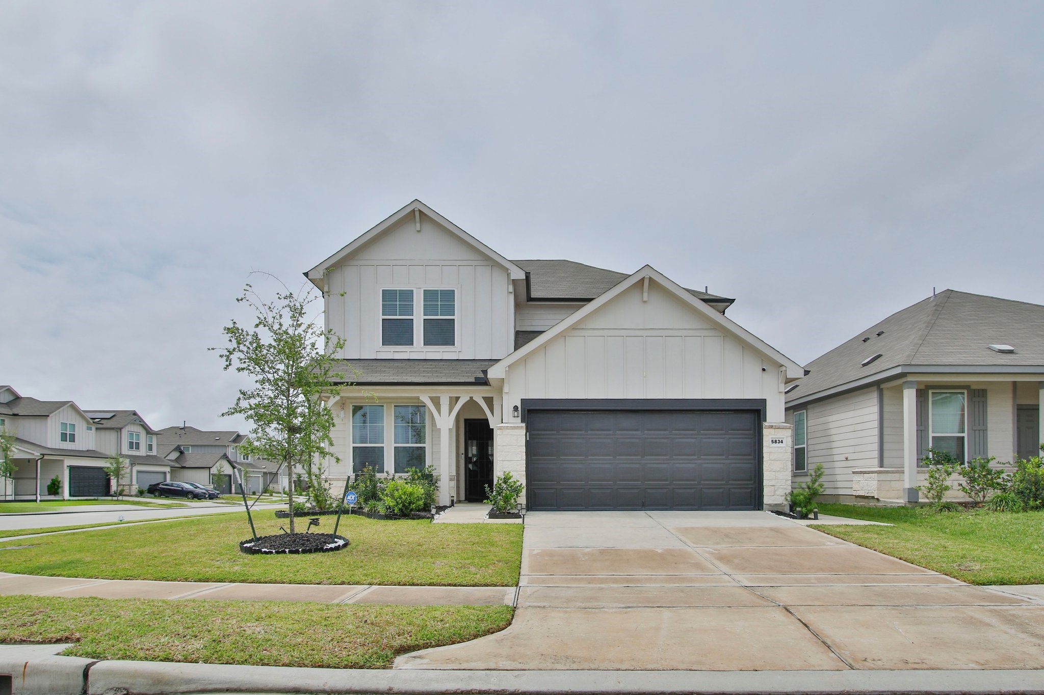 5834 Finely Run St Spring Spring, TX 77373 - Photo 2 of 50 a front view of a house with a yard and garage
