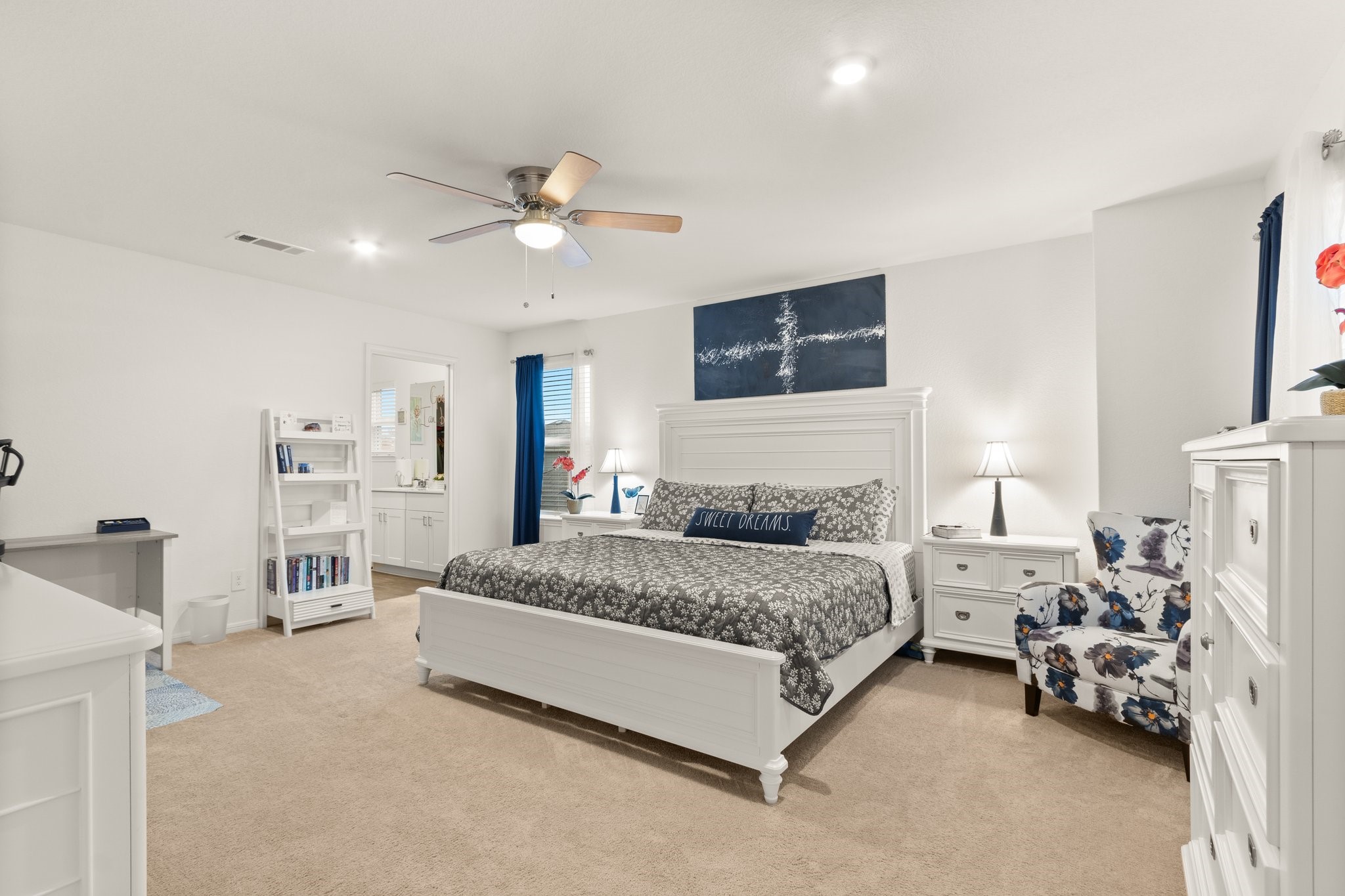 5834 Finely Run St Spring Spring, TX 77373 - Photo 21 of 50 a spacious bedroom with a bed a couch and a chandelier