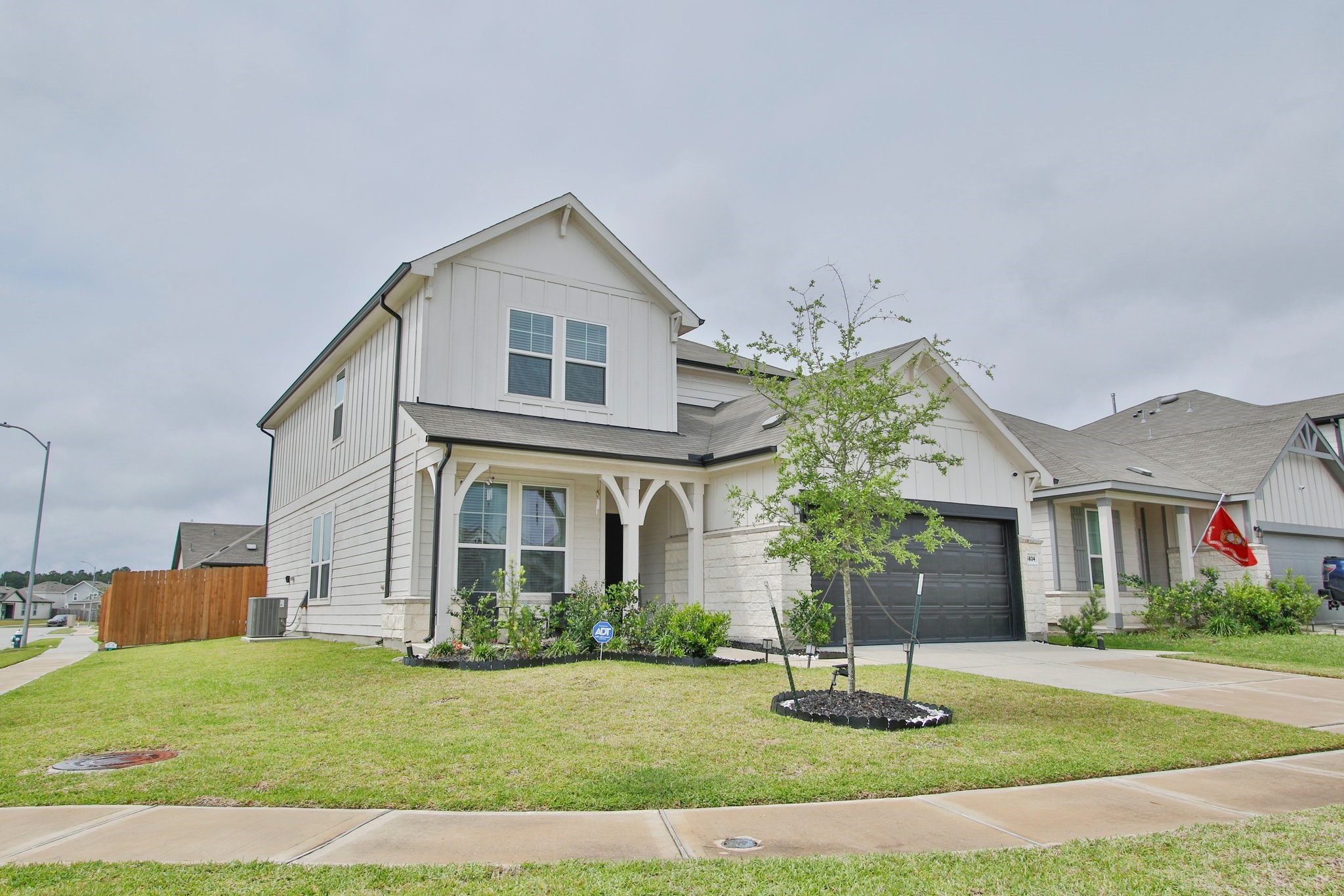 5834 Finely Run St Spring Spring, TX 77373 - Photo 3 of 50 a front view of a house with a yard and garage