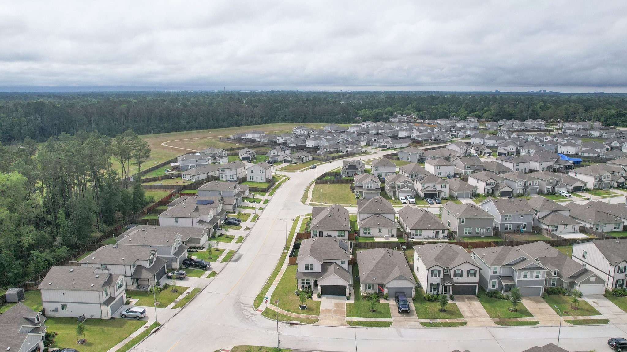 5834 Finely Run St Spring Spring, TX 77373 - Photo 44 of 50 an aerial view of a residential apartment building with a yard