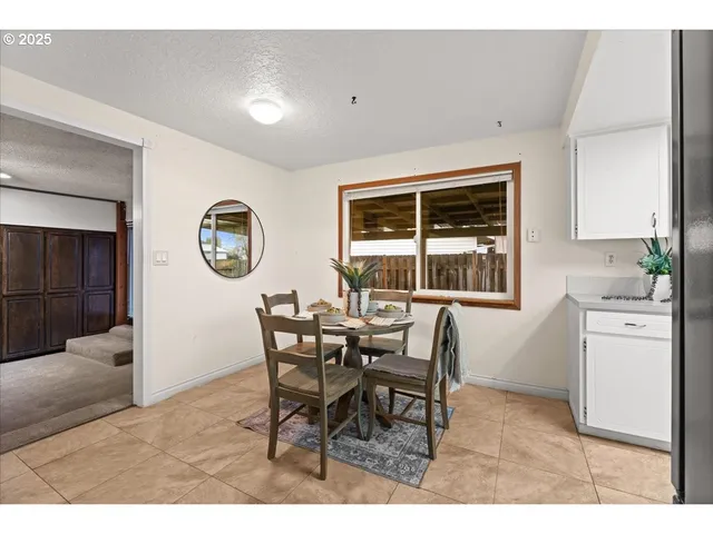 a dining room with furniture and window