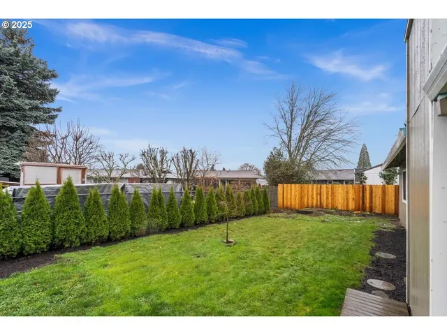 a view of yard with swimming pool and seating area