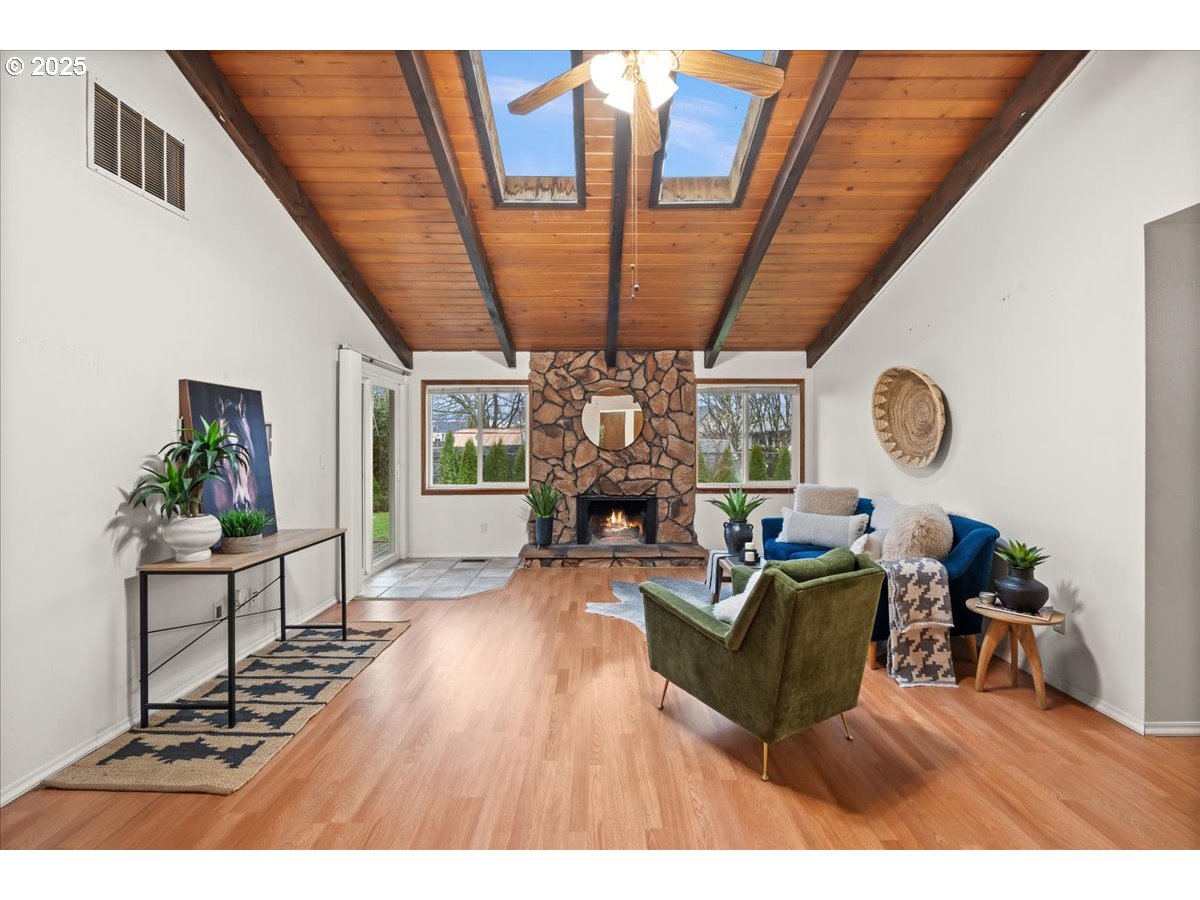253 South Tarrybrook Circle Cornelius, OR 97113 - Photo 7 of 23 a living room with furniture a fireplace a rug and a large window
