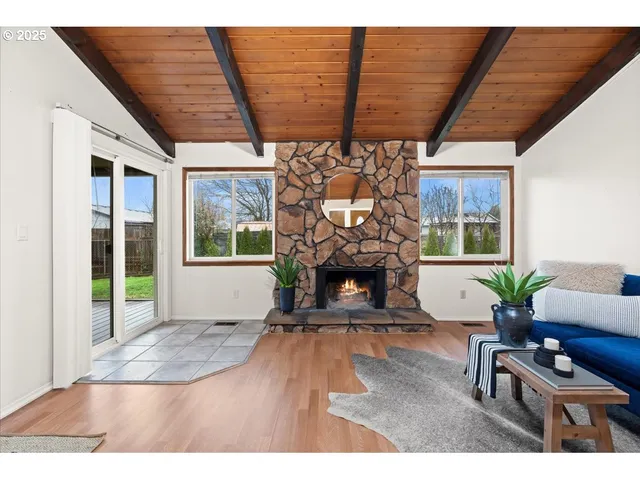 a living room with furniture a fireplace and a table