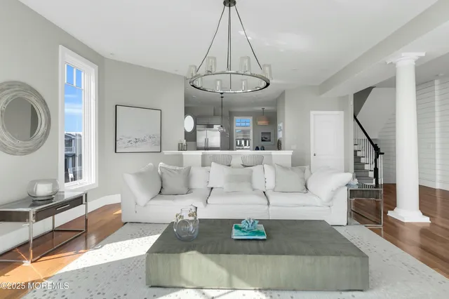 a kitchen with a dining table chairs and a chandelier