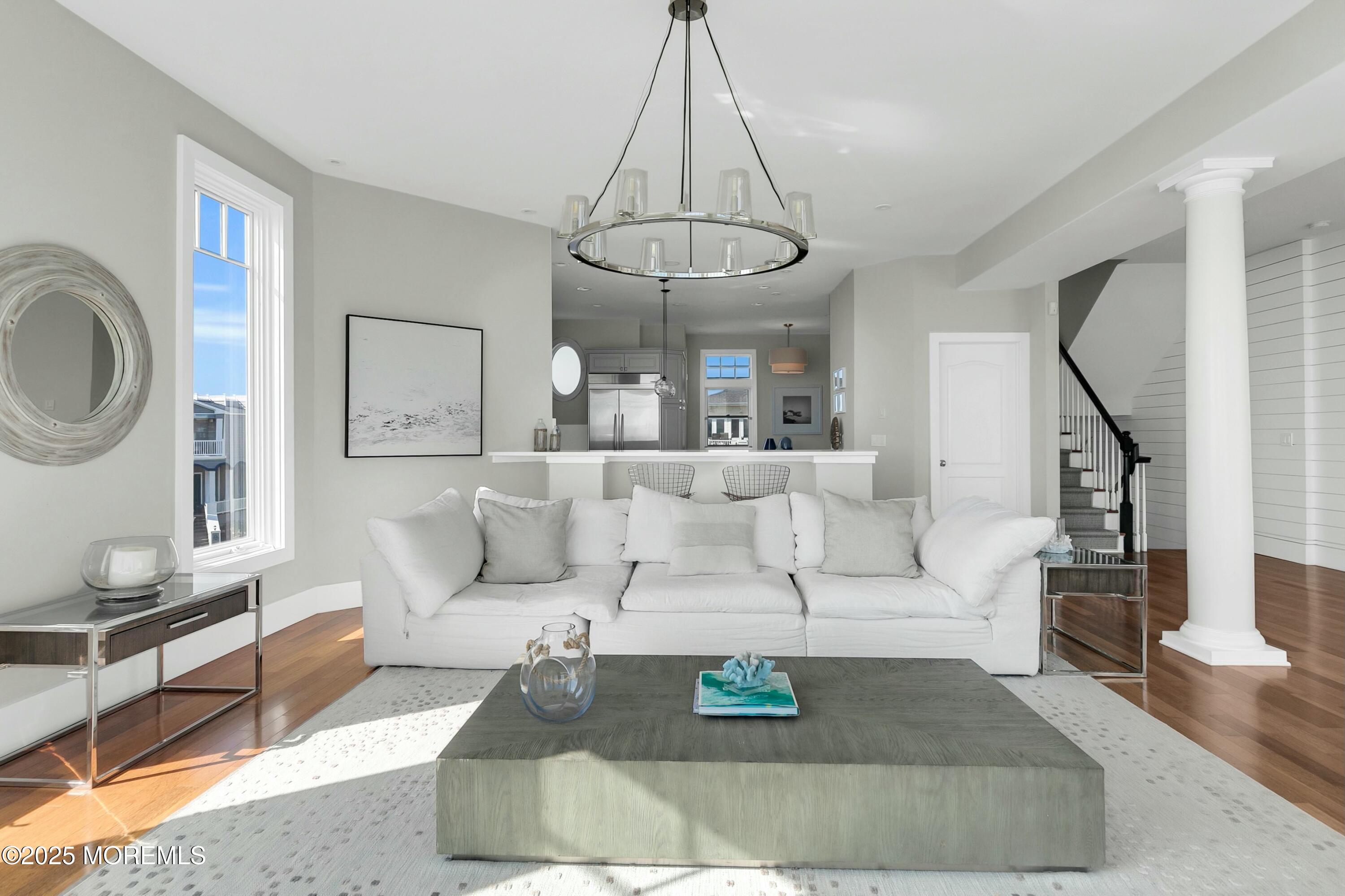 15 Tradewinds Lane Sea Bright, NJ 07760 - Photo 12 of 43 a living room with furniture a rug and a chandelier