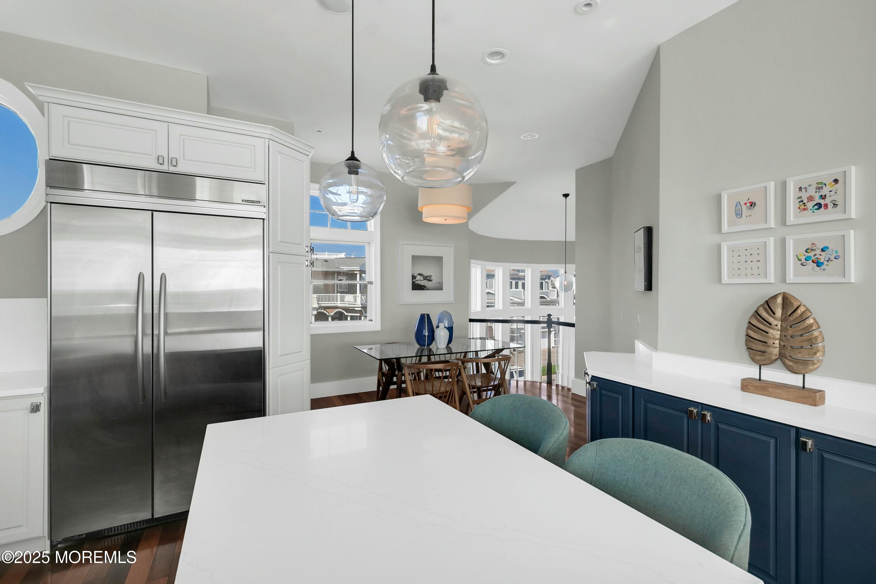 15 Tradewinds Lane Sea Bright, NJ 07760 - Photo 15 of 43 a kitchen with stainless steel appliances a refrigerator a sink dishwasher a oven with wooden cabinets and floor