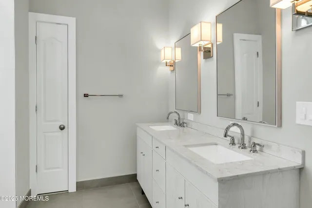 a bedroom with a large bed and windows