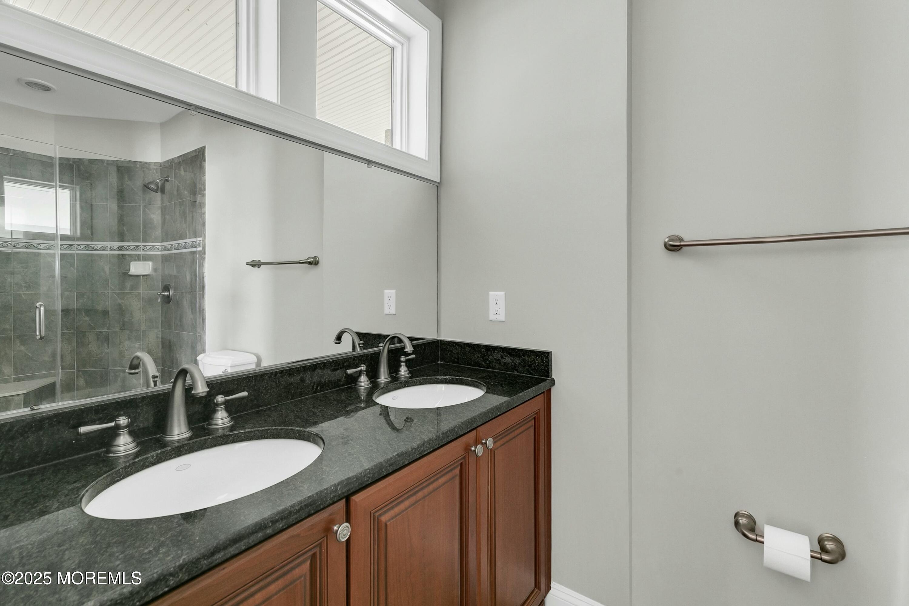 15 Tradewinds Lane Sea Bright, NJ 07760 - Photo 24 of 43 a bathroom with a granite countertop sink and a mirror
