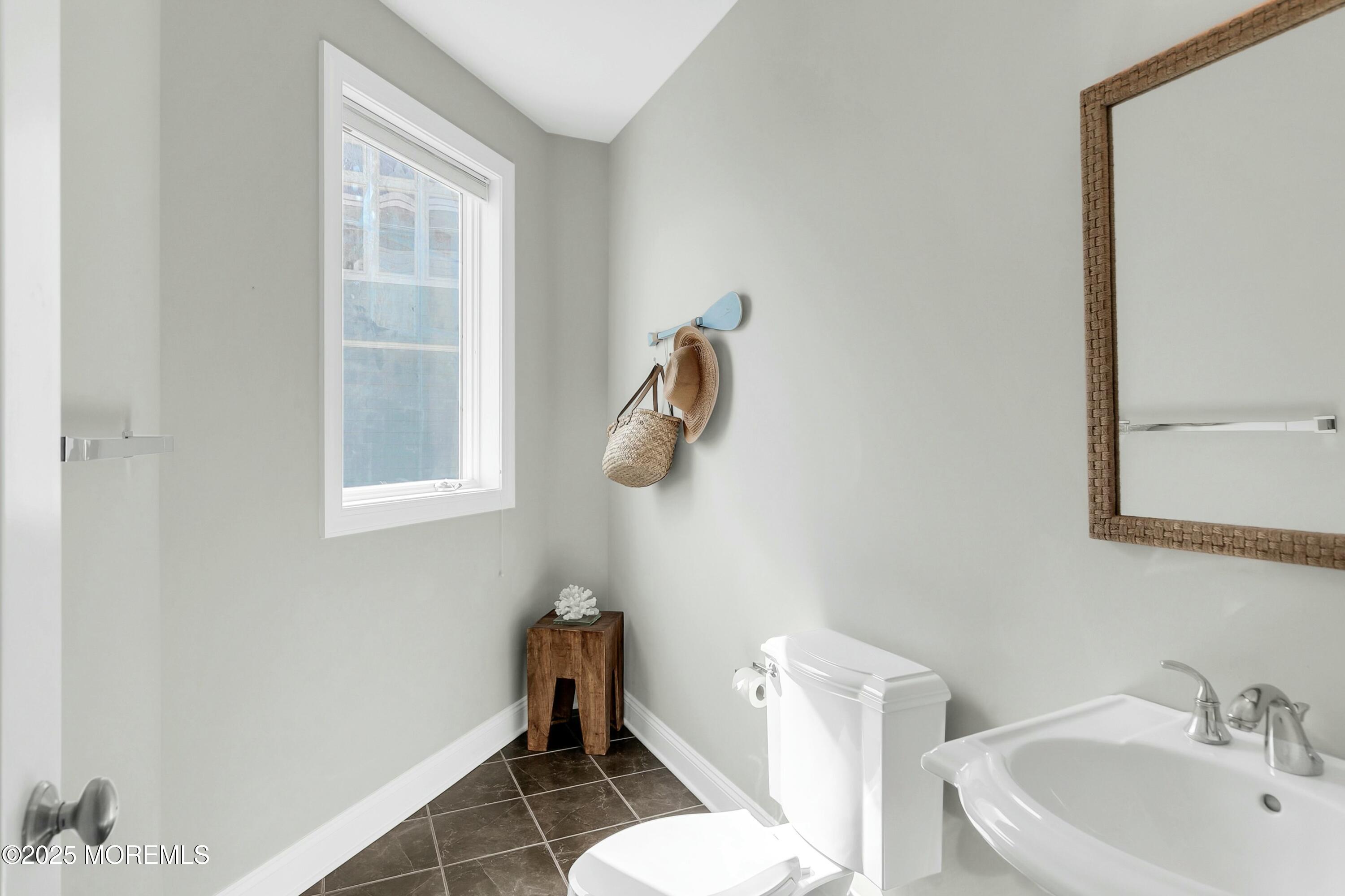 15 Tradewinds Lane Sea Bright, NJ 07760 - Photo 30 of 43 a bathroom with a sink a toilet and a mirror
