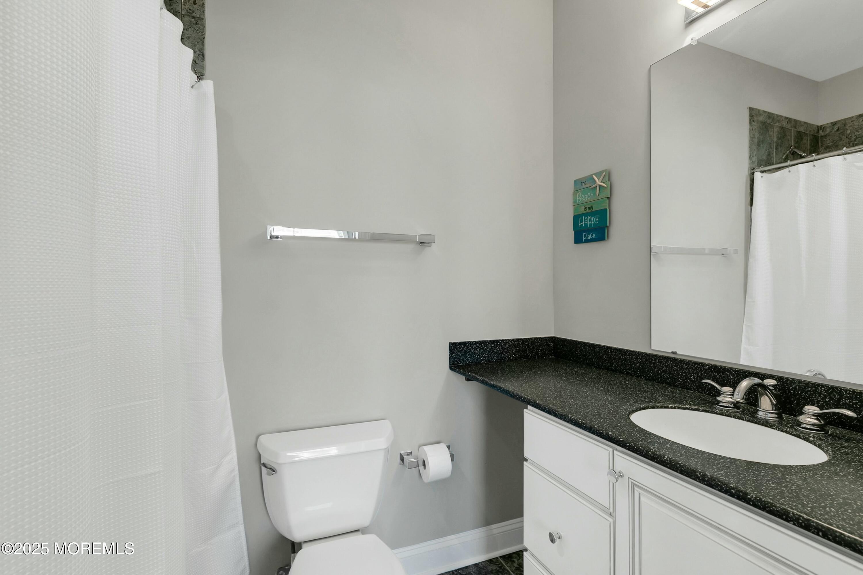 15 Tradewinds Lane Sea Bright, NJ 07760 - Photo 32 of 43 a bathroom with a granite countertop sink and a mirror