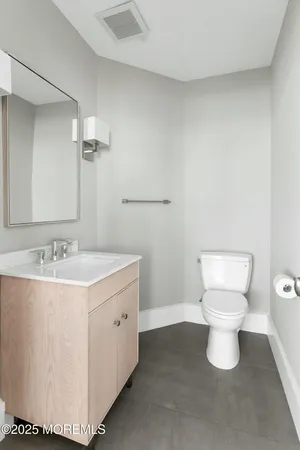 a bathroom with a sink toilet and a mirror