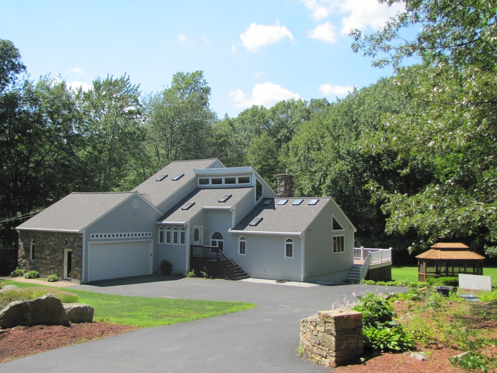 167 Mendon Road Sutton, MA 01590 - Photo 1 of 27 a front view of a house with a garden and yard