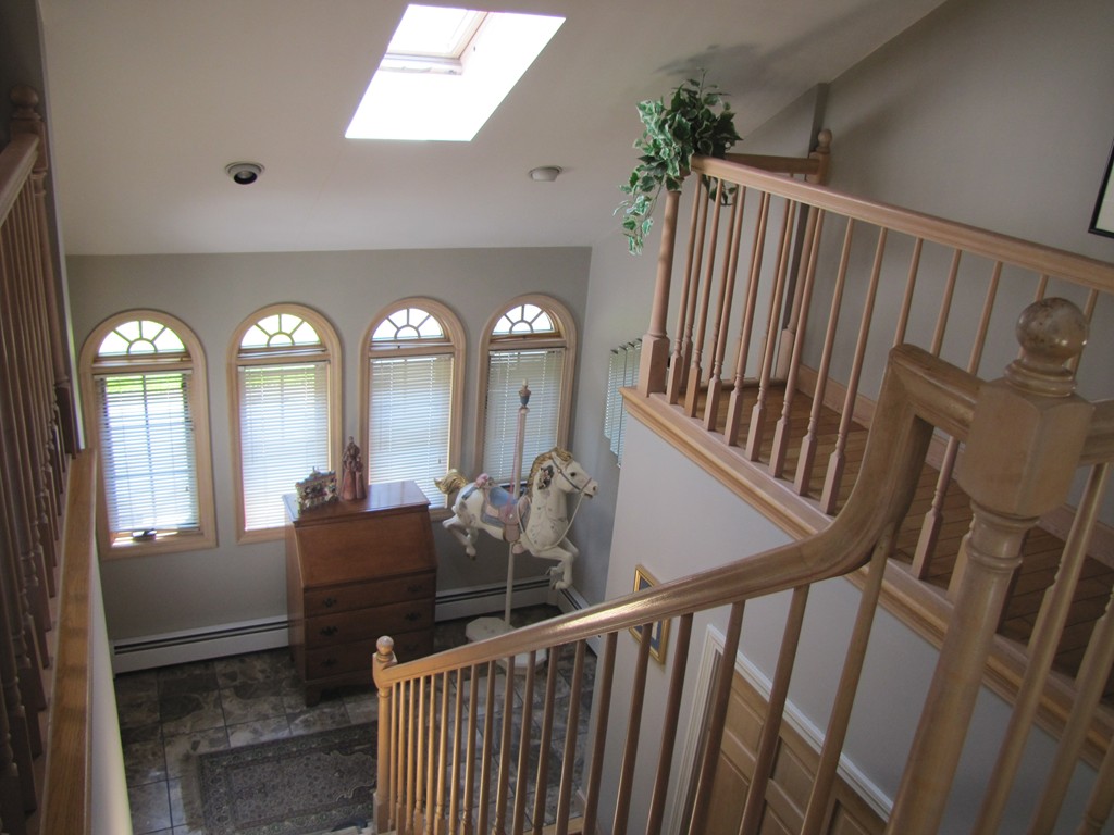 167 Mendon Road Sutton, MA 01590 - Photo 16 of 27 a view of a hallway with wooden floor and windows