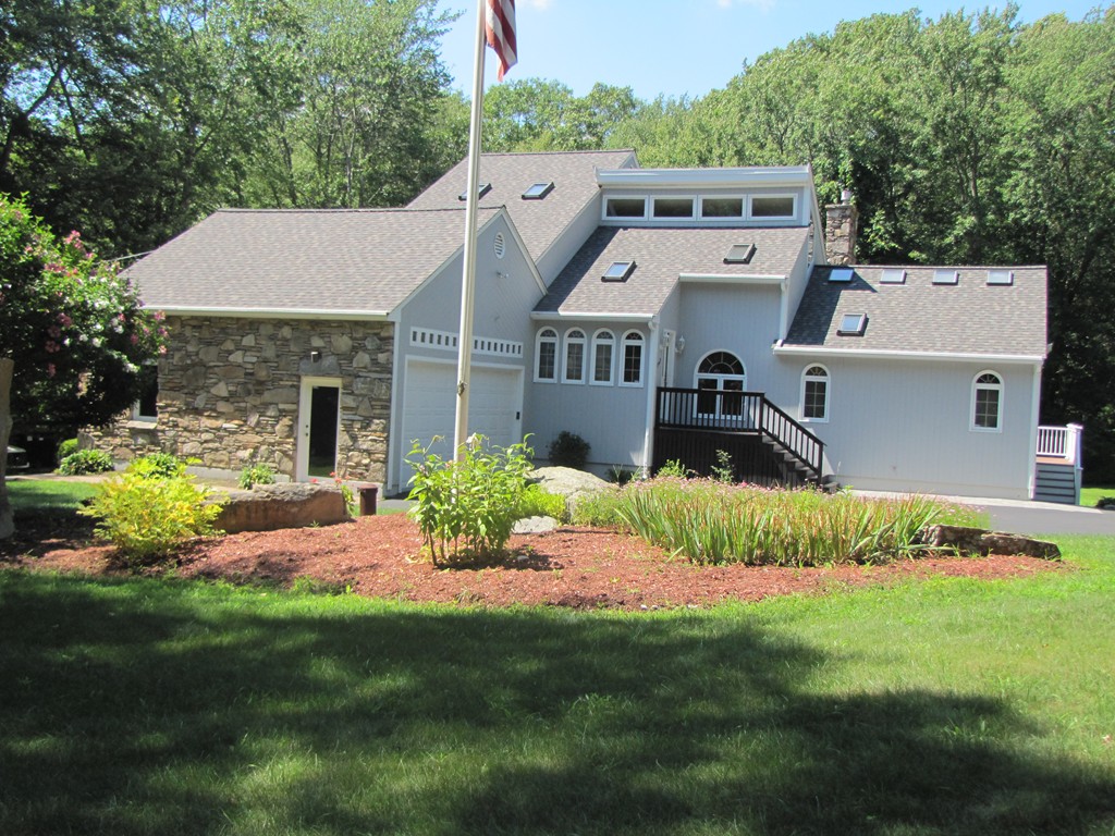 167 Mendon Road Sutton, MA 01590 - Photo 2 of 27 a front view of a house with a yard