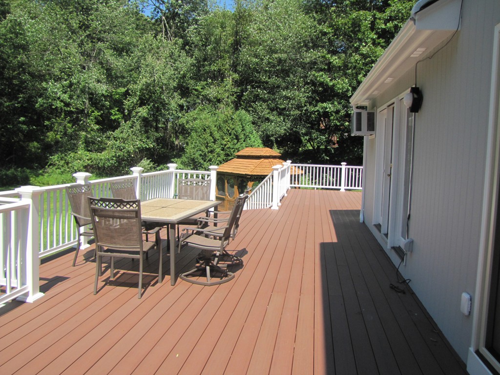167 Mendon Road Sutton, MA 01590 - Photo 23 of 27 a balcony with wooden floor table and chairs