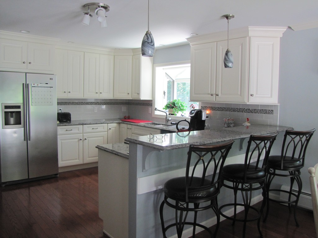 167 Mendon Road Sutton, MA 01590 - Photo 3 of 27 a kitchen with a dining table chairs refrigerator and cabinets