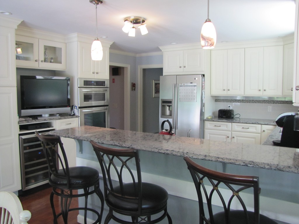 167 Mendon Road Sutton, MA 01590 - Photo 4 of 27 a kitchen with stainless steel appliances a dining table and chairs