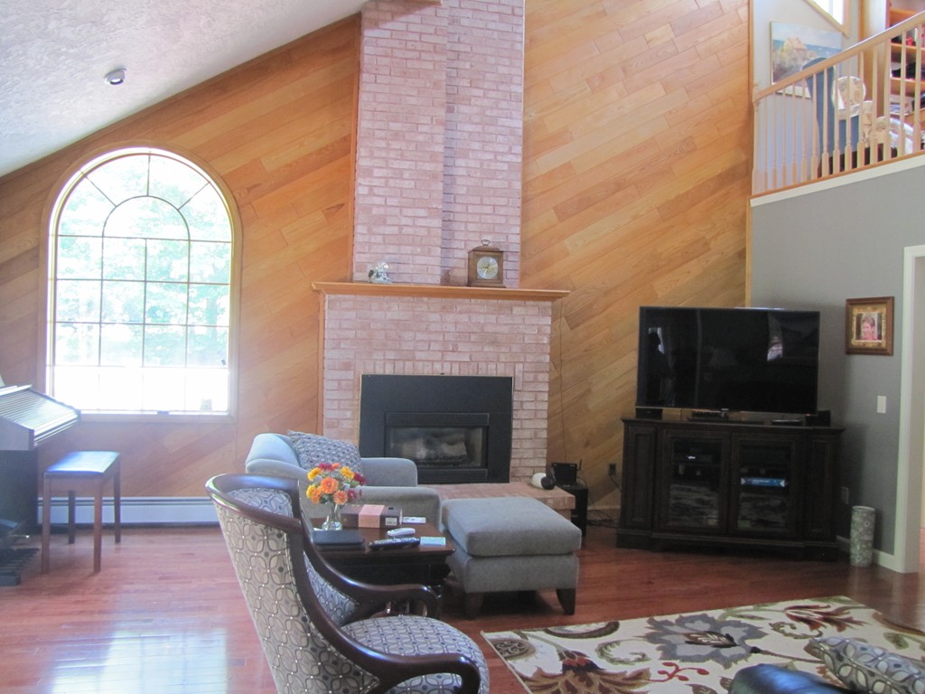 167 Mendon Road Sutton, MA 01590 - Photo 6 of 27 a living room with furniture and a fireplace