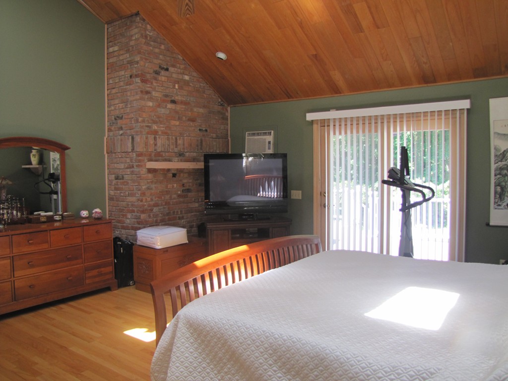 167 Mendon Road Sutton, MA 01590 - Photo 9 of 27 a bedroom with a bed and a television