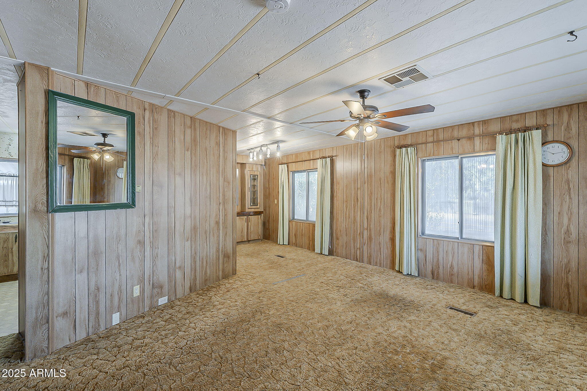 1617 South Cortez Road, Unit 1 Apache Junction, AZ 85119 - Photo 7 of 33 a view of a livingroom with a chandelier fan and windows