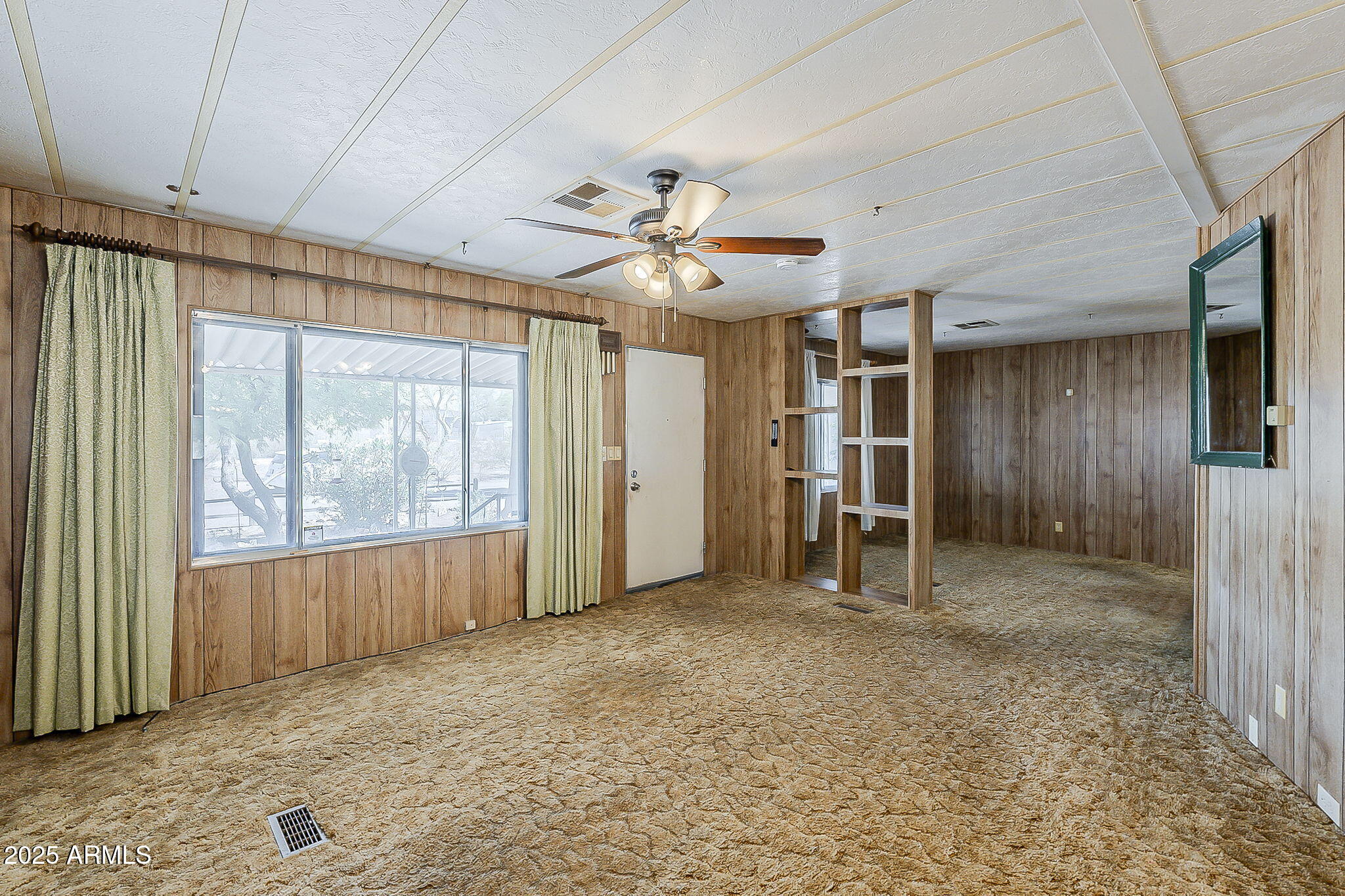 1617 South Cortez Road, Unit 1 Apache Junction, AZ 85119 - Photo 9 of 33 a view of empty room with a ceiling fan and window