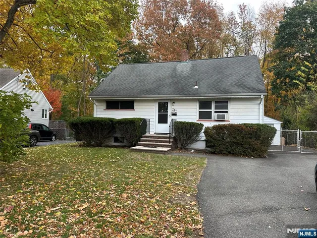 a house view with a sitting space and garden