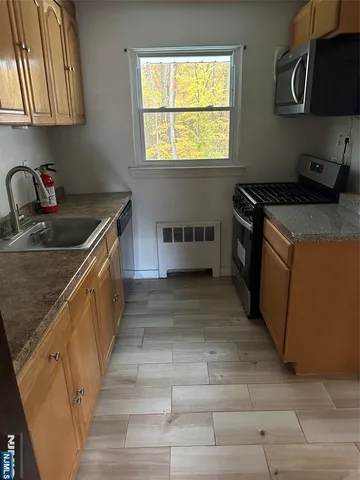 a kitchen that has a sink and a stove