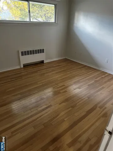 an empty room with wooden floor
