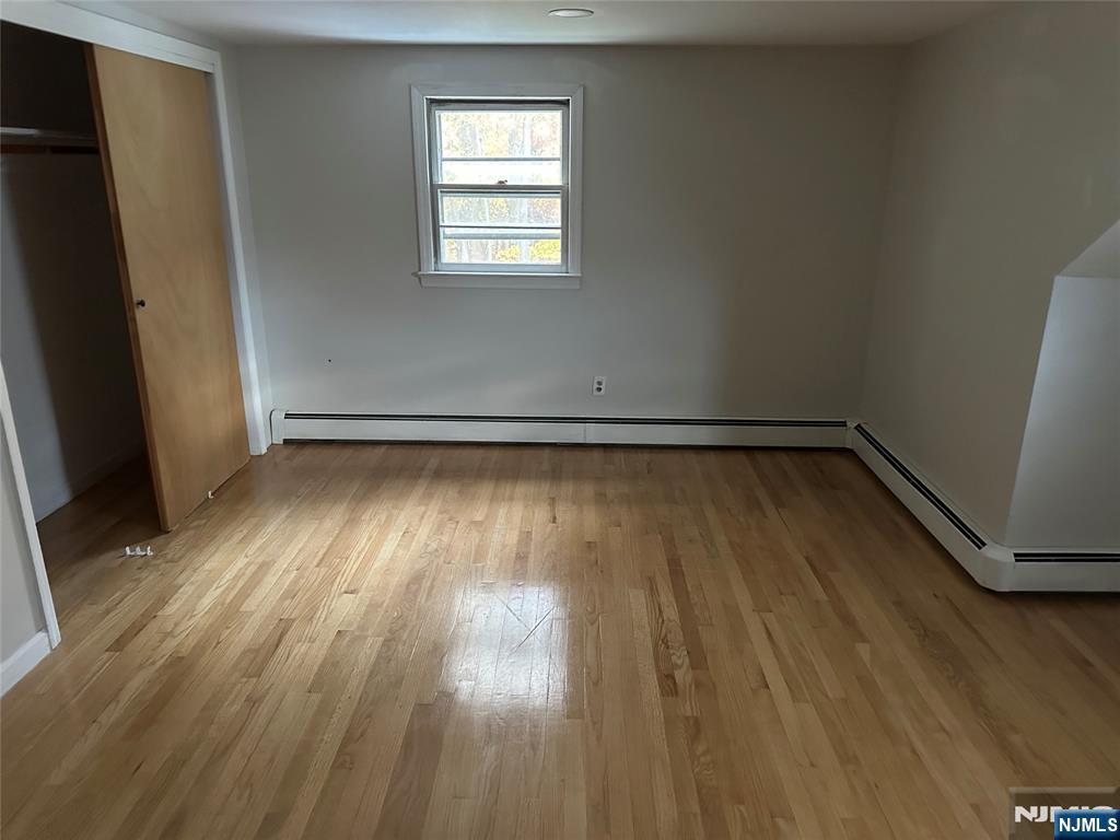 743 Newcomb Road Ridgewood, NJ 07450 - Photo 8 of 16 an empty room with wooden floor and windows