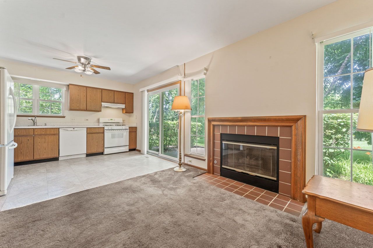 1228 Coldspring Road Elgin, IL 60120 - Photo 12 of 30 a view of a livingroom with a fireplace cabinet and windows