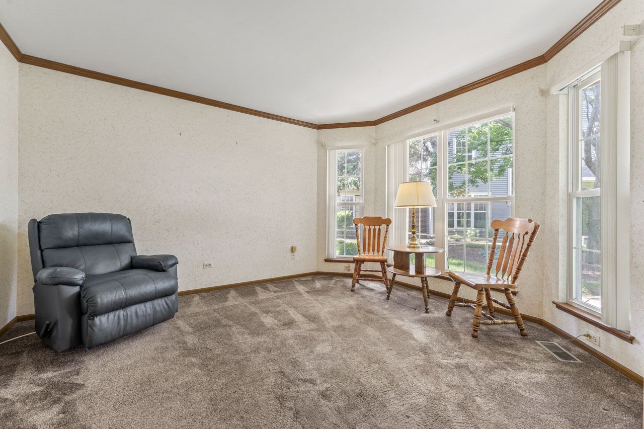 1228 Coldspring Road Elgin, IL 60120 - Photo 7 of 30 a living room with furniture and a window