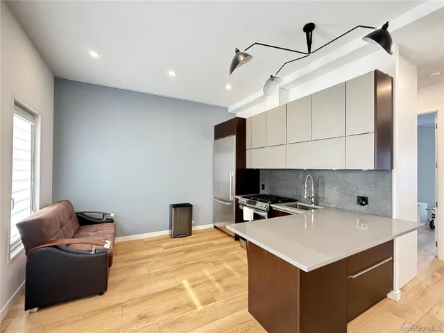 a kitchen with a stove a refrigerator and a sink