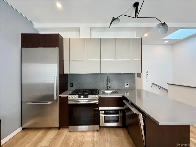 a kitchen with a refrigerator and a stove top oven