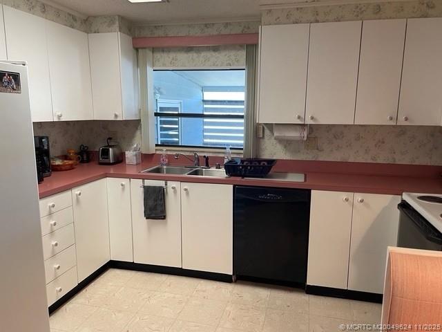 2883 Southwest Monarch Trail Stuart, FL 34997 - Photo 11 of 17 a kitchen with white cabinets and white appliances