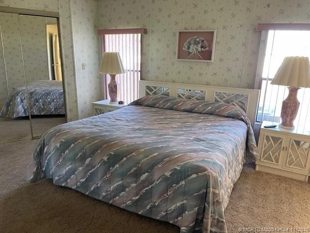 2883 Southwest Monarch Trail Stuart, FL 34997 - Photo 13 of 17 a bedroom with a bed and a painting on the wall