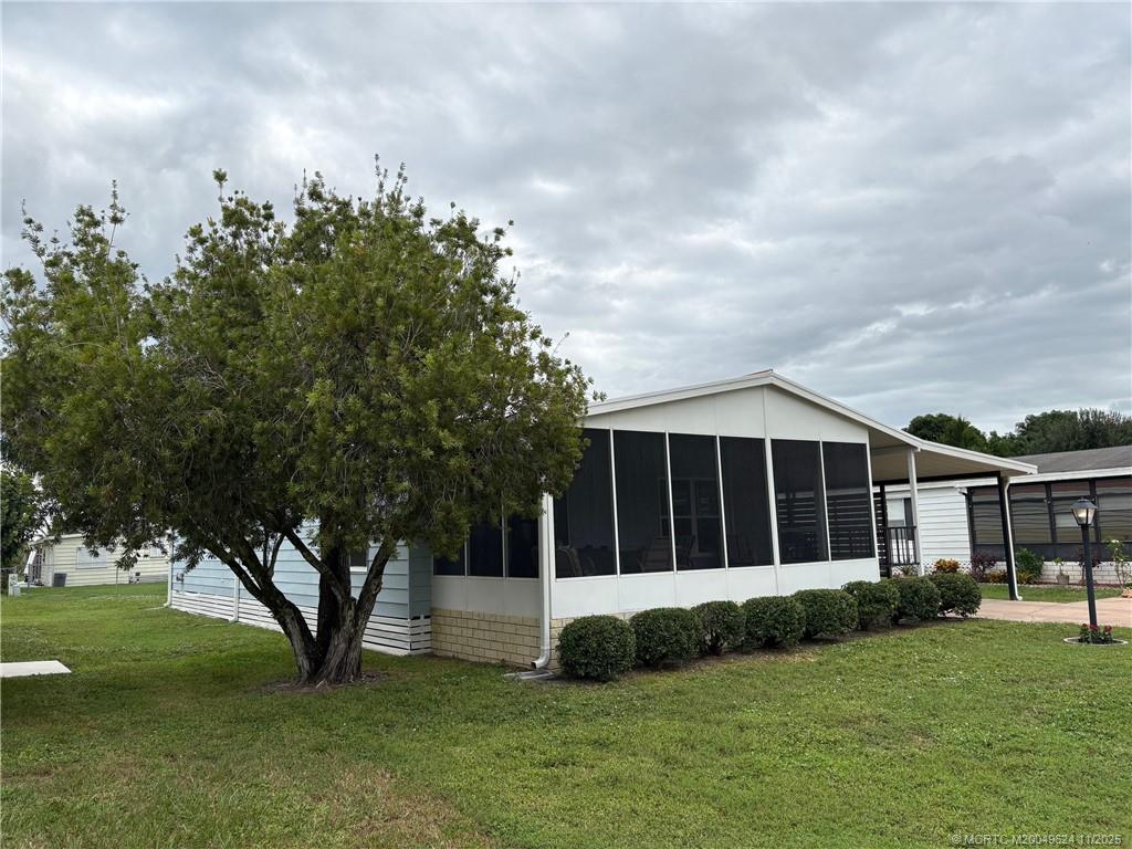 2883 Southwest Monarch Trail Stuart, FL 34997 - Photo 2 of 17 a view of a house with a garden
