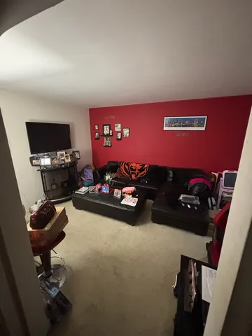 a kitchen with refrigerator and chairs