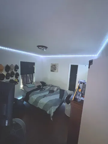 a living room with furniture and a air conditioner vent