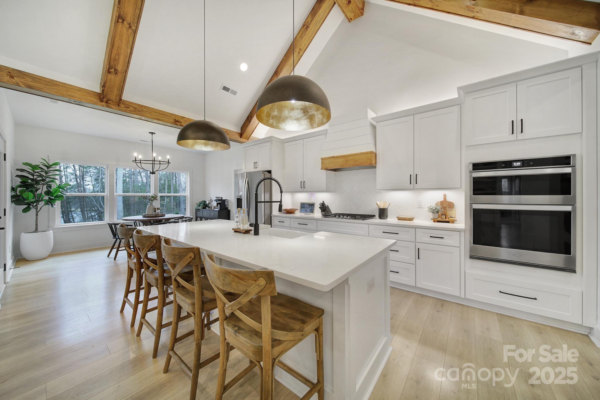 856 Bellegray Road Clover, SC 29710 - Photo 13 of 48 a kitchen with stainless steel appliances a table chairs in it and wooden floors
