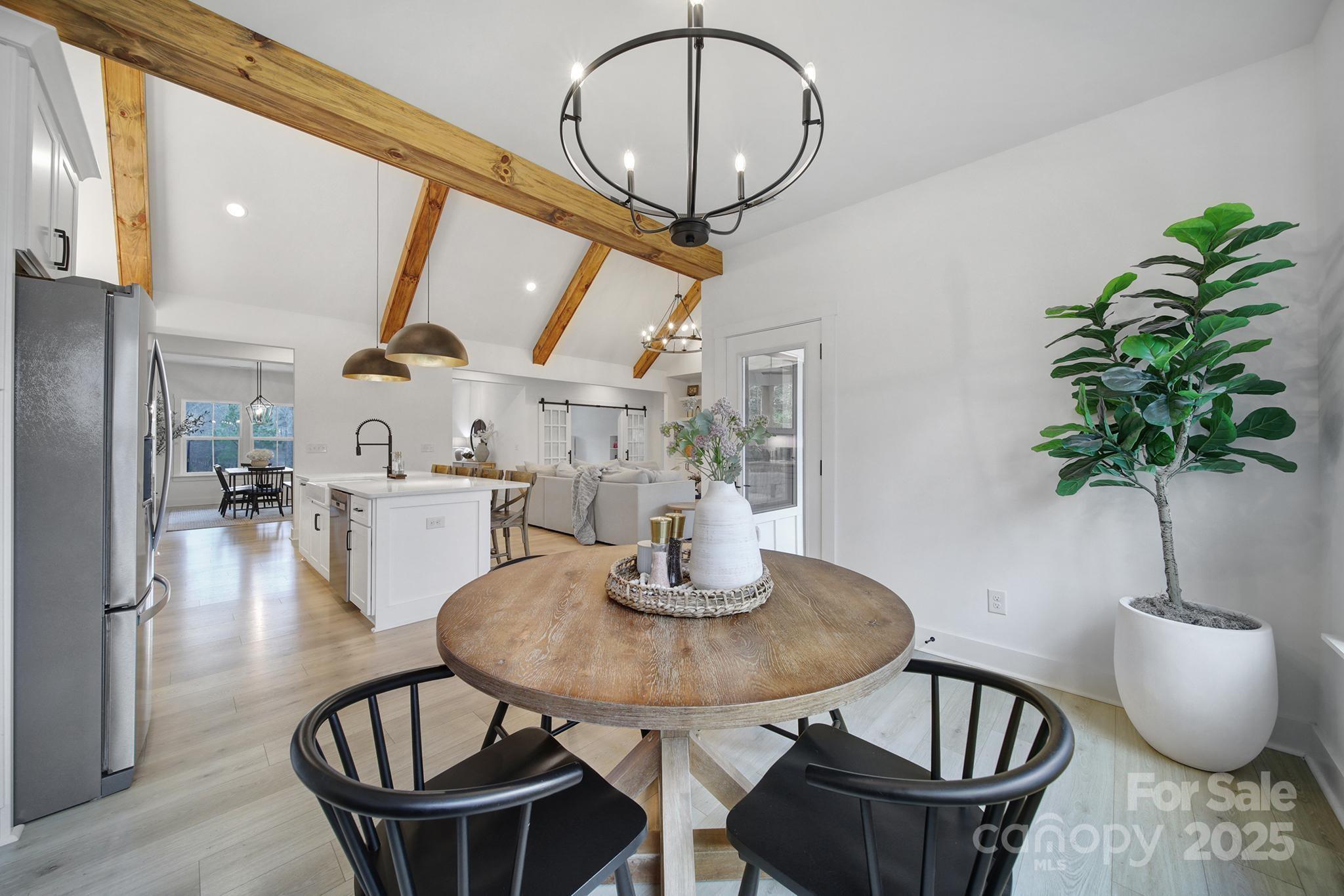 856 Bellegray Road Clover, SC 29710 - Photo 14 of 48 a dining room with furniture potted plants and wooden floor