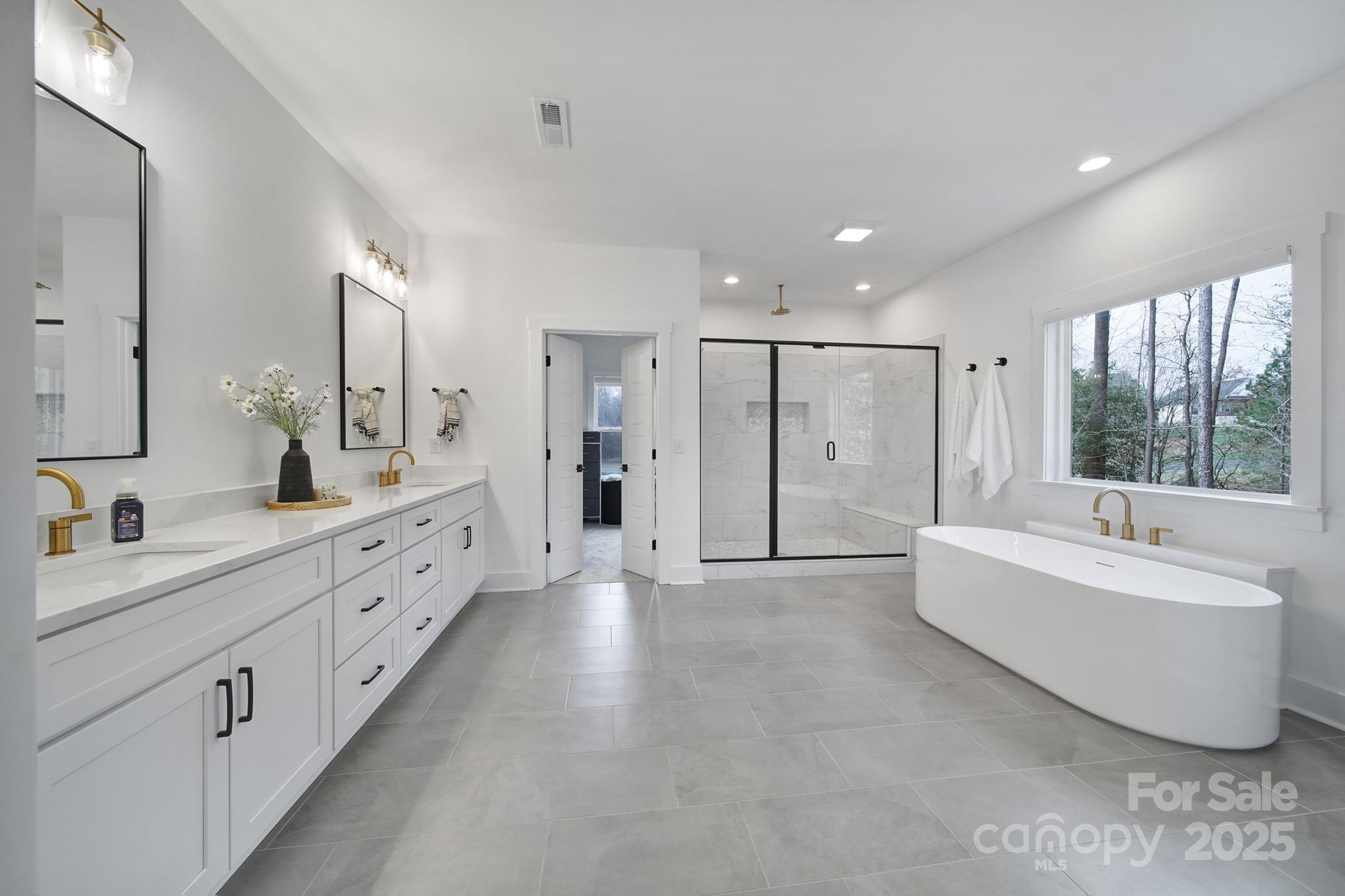 856 Bellegray Road Clover, SC 29710 - Photo 21 of 48 a large bathroom with a double vanity sink large mirror and a bathtub
