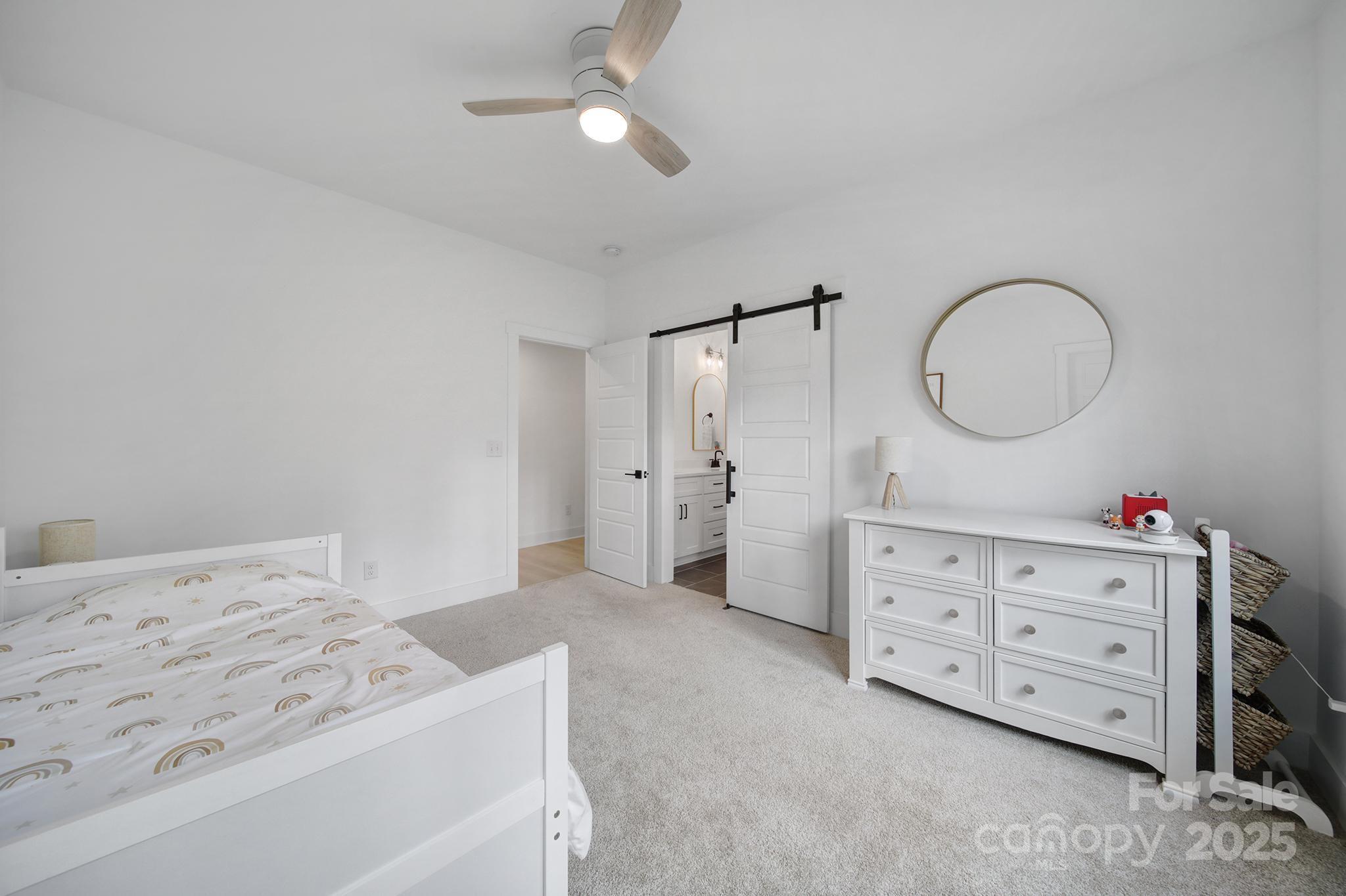 856 Bellegray Road Clover, SC 29710 - Photo 29 of 48 a spacious bedroom with a bed a dresser and a chandelier